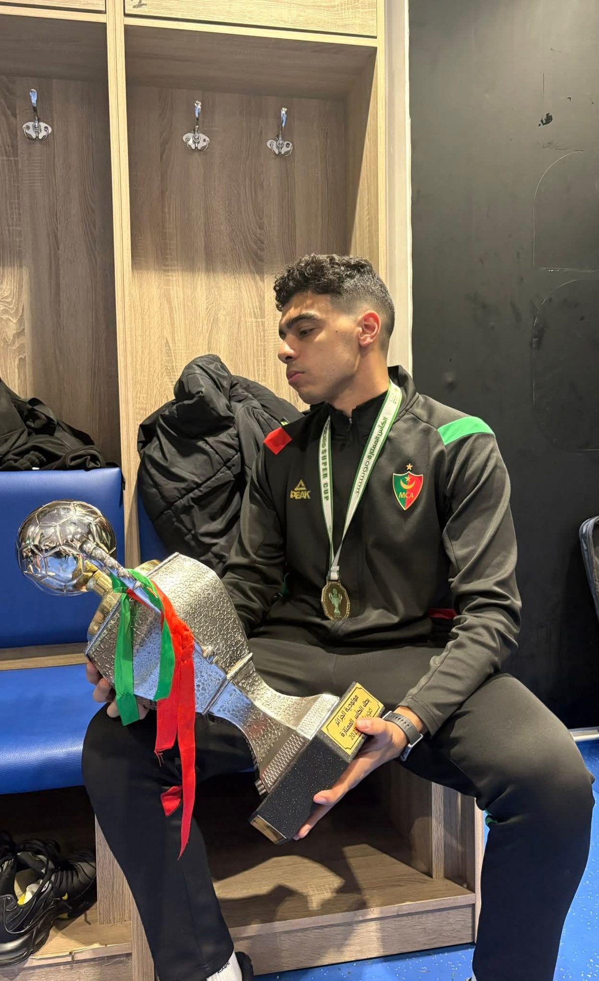 Graduate with Algerian cup trophy