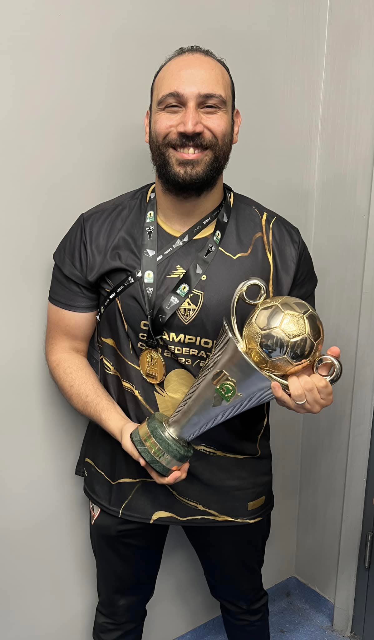 Graduate with CAF Confederation Cup trophy