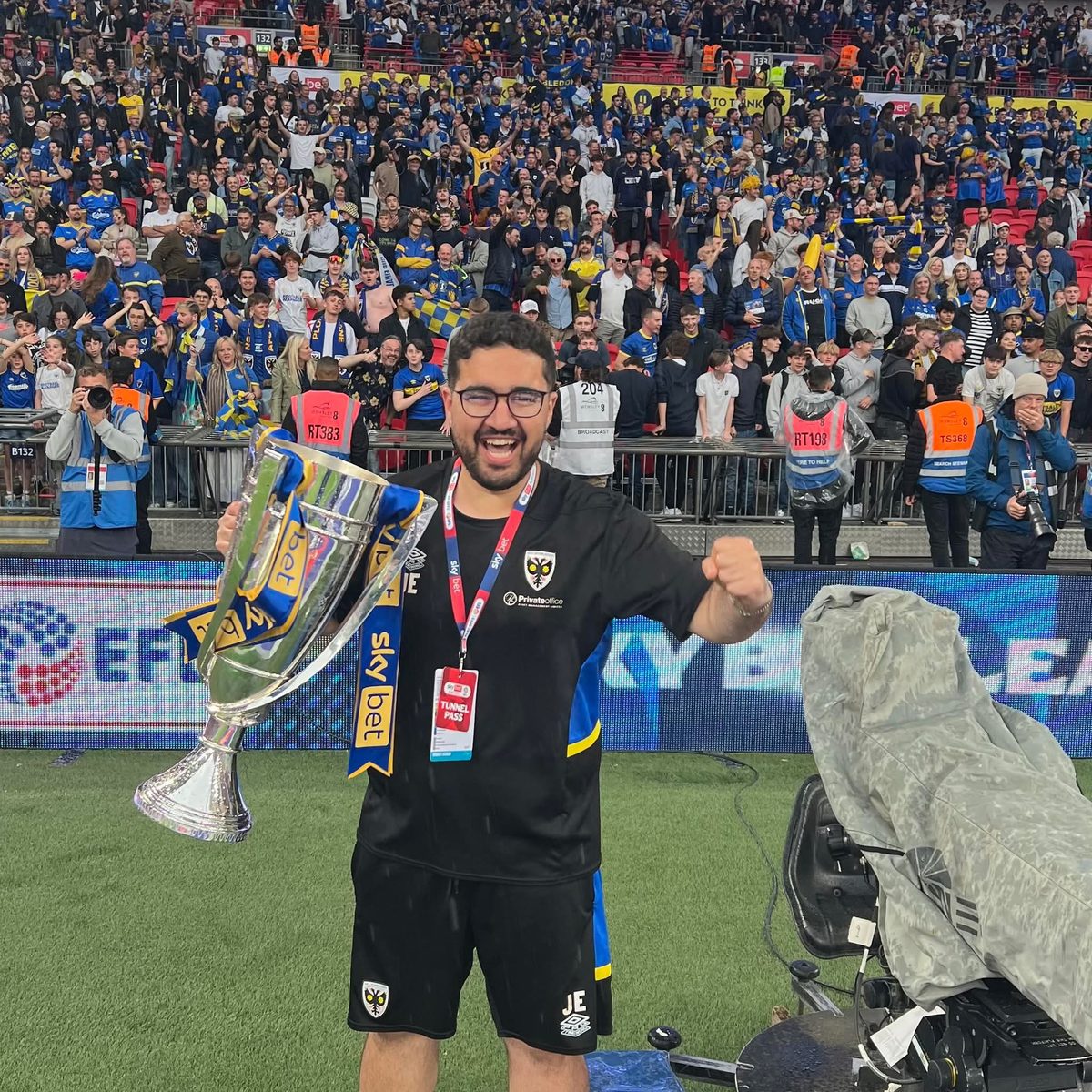 Graduate with EFL Sky Bet trophy at AFC Wimbledon