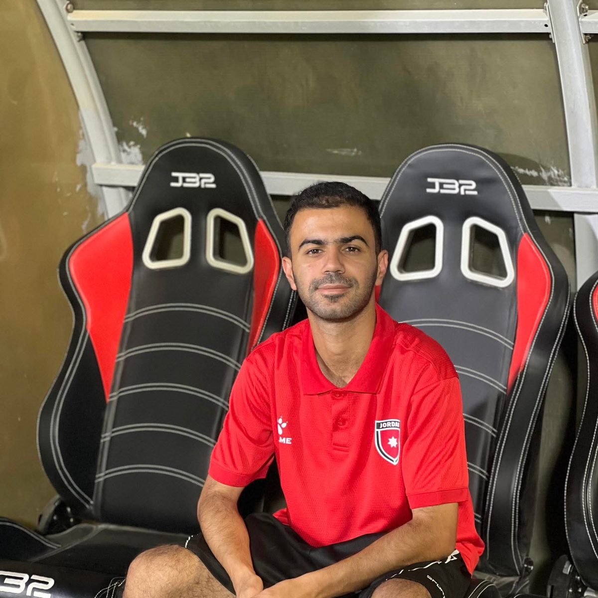 Graduate in Jordan FA shirt on team bench