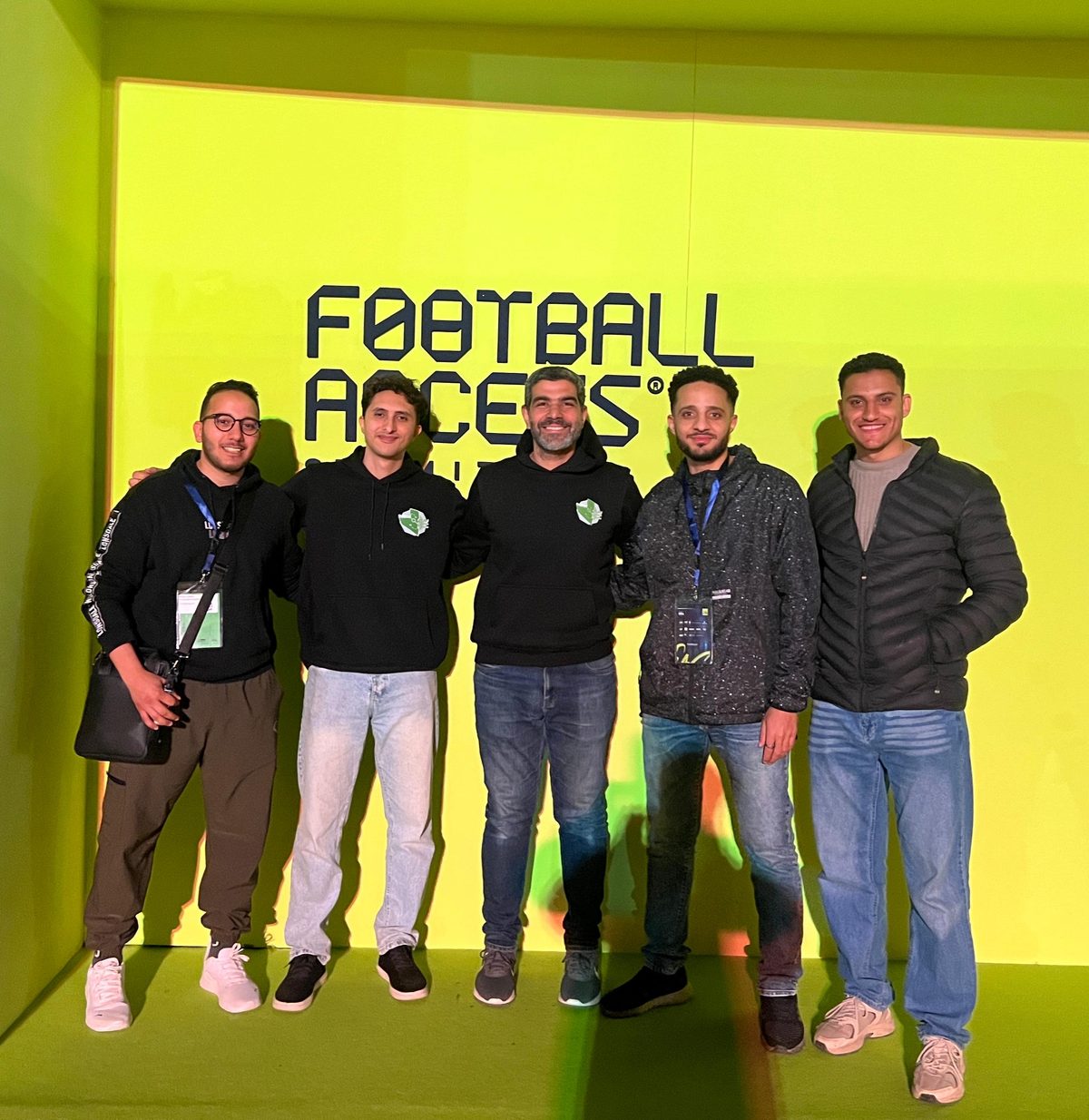Team in front of Football Access wall